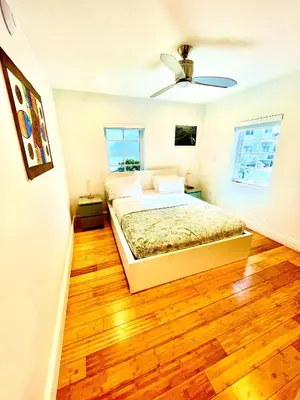 a bedroom with a bed and a wooden floor at 12 GUESTS LUXURIOUS SOUTH BEACH SUITE 2 in Miami Beach