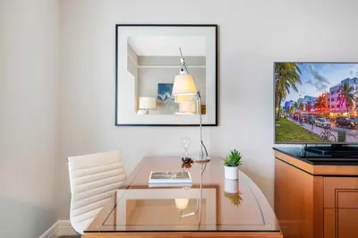 a dining room with a glass table and a picture on the wall at 1435 Brickell Ave 3004 in Miami