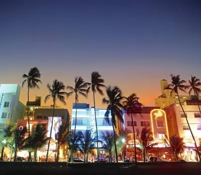 a group of palm trees in front of a building at BEST DEAL! 2 Bedroom Modern Beachfront by YouRent! in Miami Beach
