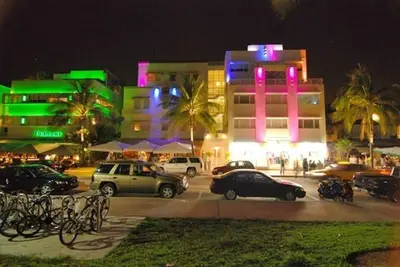 a parking lot with cars parked in front of buildings at night at BEST DEAL! 2 Bedroom Modern Beachfront by YouRent! in Miami Beach