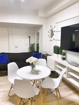 a living room with a white table and white chairs at BEST DEAL! 2 Bedroom Modern Beachfront by YouRent! in Miami Beach