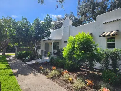a white house with plants in the yard at Rio Vista Prestige on Las Olas Heated Pool in Fort Lauderdale