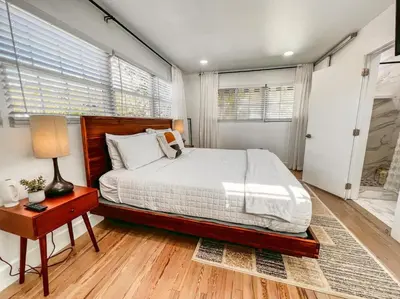 a bedroom with a bed and a table with a lamp at Rio Vista Prestige on Las Olas Heated Pool in Fort Lauderdale