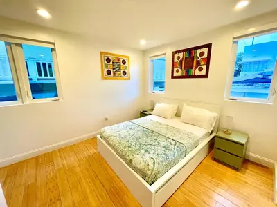 a bedroom with a bed and two windows at 16 GUESTS LUXURIOUS SOUTH BEACH SUITE WITH ROOFTOP 2 in Miami Beach