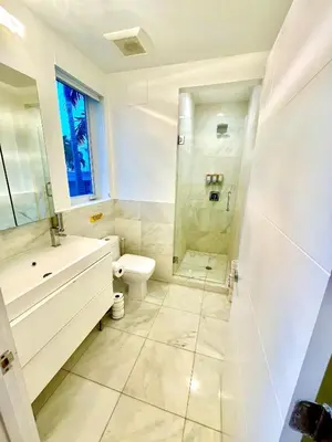 a bathroom with a shower and a toilet and a sink at 16 GUESTS LUXURIOUS SOUTH BEACH SUITE WITH ROOFTOP 2 in Miami Beach