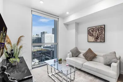 a living room with a white couch and a glass table at Prime Location 1-Bed Retreat With Free Parking in Miami
