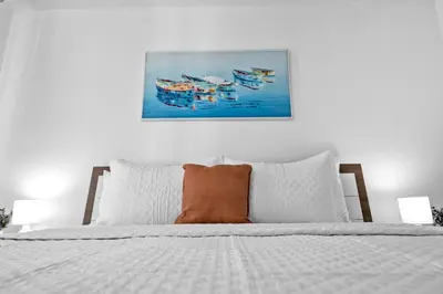 a bed with an orange pillow on top of it at Spacious 2 Bed Unit in Brickell with Free Parking in Miami