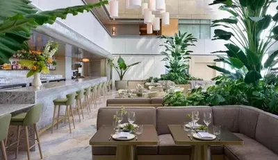 a restaurant with couches and a bar with plants at Brickell 31th Floor Sea View Free Parking by Palermo Home Miami in Miami