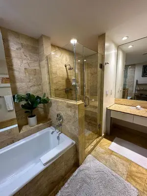 a bathroom with a tub and a shower and a sink at Brickell 31th Floor Sea View Free Parking by Palermo Home Miami in Miami
