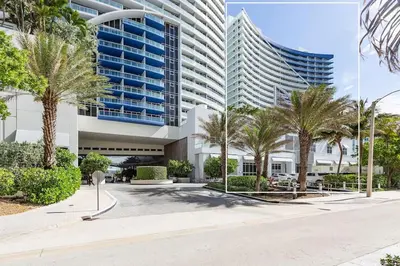 a large building with palm trees in front of it at 2BR W Residence, FLL Beach, Oceanside, pools, hot tub, bar credit in Fort Lauderdale