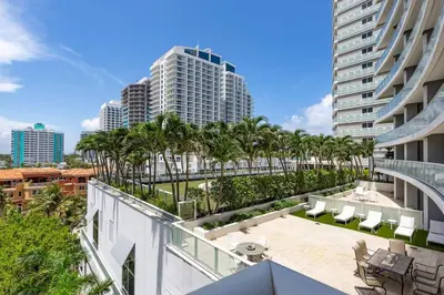 an apartment balcony with palm trees and buildings at 2BR W Residence, FLL Beach, Oceanside, pools, hot tub, bar credit in Fort Lauderdale