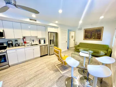 a kitchen and living room with a couch and a table at 60 Guests Luxury South Beach Private Estate in Miami Beach