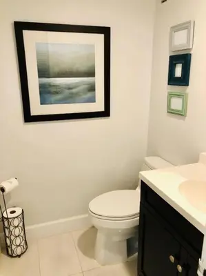 a bathroom with a toilet and a picture on the wall at Special $$$! 2 Bedroom Oceanfront Condo in Hollywood/Hallandale Beach! in Hollywood