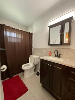 a bathroom with a toilet and a sink and a shower at Private Studio Near Guitar Casino & Stadium in Carver Ranches