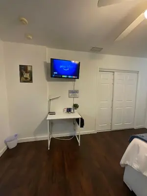 a room with a desk and a tv on the wall at Private Studio Near Guitar Casino & Stadium in Carver Ranches