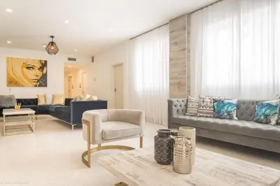 a living room with a couch and a chair at Hotel Belleza in Miami Beach