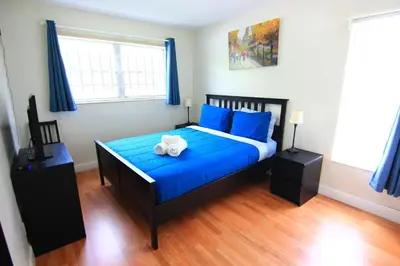 a bedroom with a blue bed with a stuffed animal on it at Sunny Isles Apartments by MiaRentals in Sunny Isles Beach