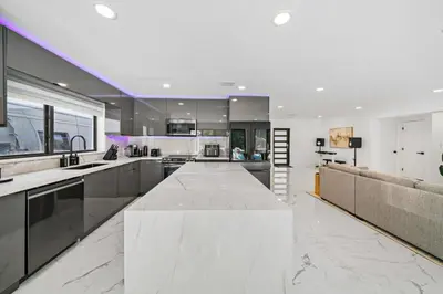 a large kitchen with a large marble counter top at Luxury Villa Azure with Heated Pool 20 minutes to Beach in Miami