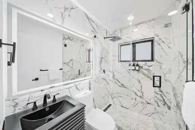 a white bathroom with a sink and a mirror at Luxury Villa Azure with Heated Pool 20 minutes to Beach in Miami