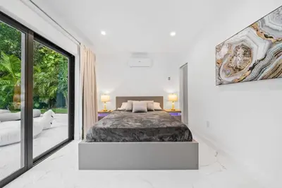 a bedroom with a bed and a large window at Luxury Villa Azure with Heated Pool 20 minutes to Beach in Miami