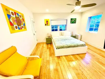 a bedroom with a bed and a couch at 30 GUESTS LUXURY SOUTH BEACH SUITES w ROOFTOP in Miami Beach