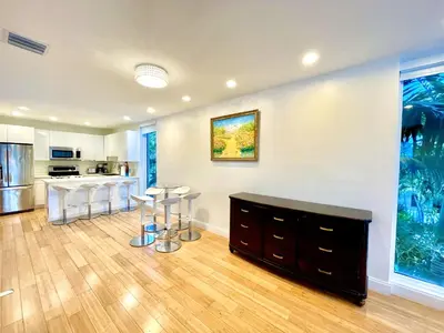 a living room with a kitchen and a dining room at 30 GUESTS LUXURY SOUTH BEACH SUITES w ROOFTOP in Miami Beach