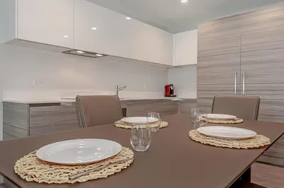 a dining room table with plates and glasses on it at Hollywood Beach Rooftop Pool Balcony in Hollywood