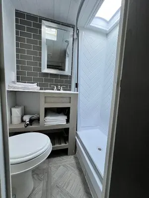 a bathroom with a toilet and a sink and a shower at Free BBQ in RV With Private entrance in Homestead
