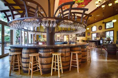 a bar with wine glasses hanging from the ceiling at Free BBQ in RV With Private entrance in Homestead