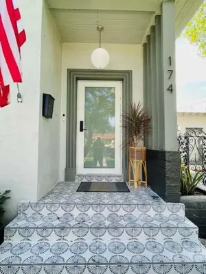 a front door of a house with a flag at Stylish Room close to everything in Miami in Miami Shores