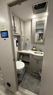 a small bathroom with a toilet and a sink at Private Cozy R/V , for your enjoyment in Tamiami