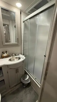 a bathroom with a shower and a sink and a toilet at Private Cozy R/V , for your enjoyment in Tamiami