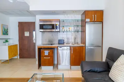 a living room with a couch and a kitchen at 1-Bed Apt with rooftop pool Ocean Dr by the Beach B207 in Miami Beach