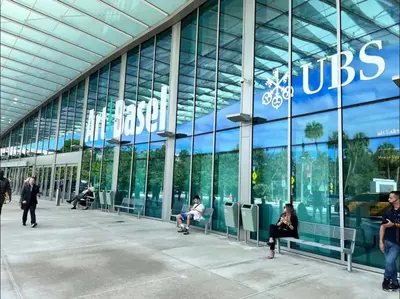 people sitting on benches in front of a building at Hotel Miami Beach Convention Center in Miami Beach