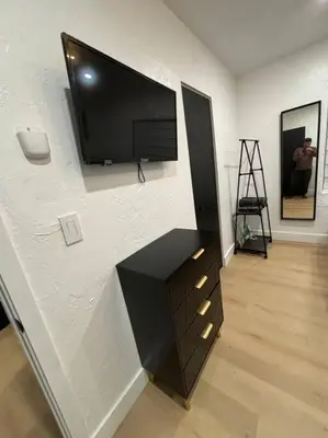 a living room with a tv on a wall at Sri House in Miami