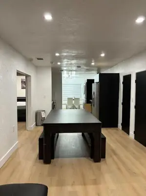 a room with a table in the middle of a room at Sri House in Miami