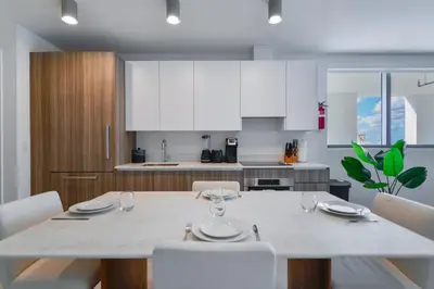 a white kitchen with a table and chairs at Prime location: Luxury Condo at brickell in Miami