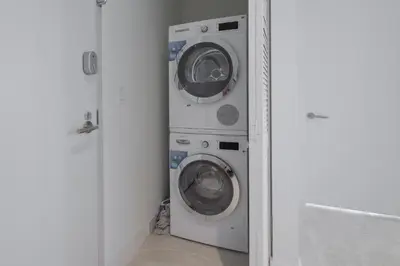 a washer and dryer in a corner of a room at Prime location: Luxury Condo at brickell in Miami