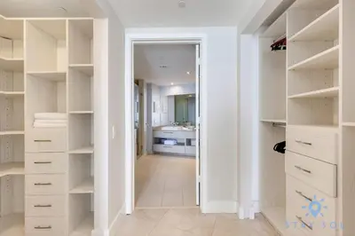 a walk in closet with white cabinets and a bathroom at Oceanview Luxury 3BR Sky Home Amaizing Pool in Hollywood