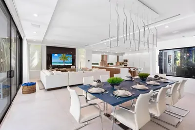 a dining room with a blue table and white chairs at Villa Celine in Fort Lauderdale