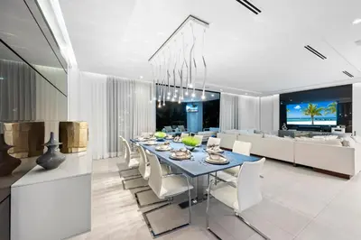 a dining room with a blue table and white chairs at Villa Celine in Fort Lauderdale