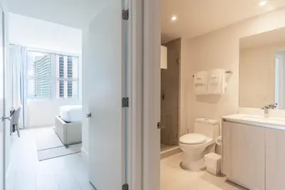 a white bathroom with a toilet and a sink at Amazing Pools Luxury 2Br Front Ocean Bay View in Hollywood