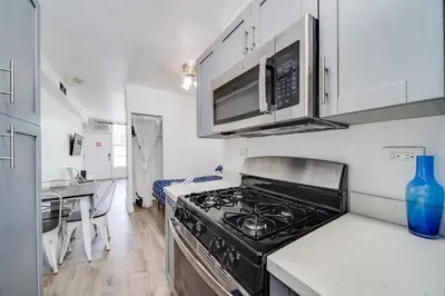 a kitchen with a stove and a microwave at Ocean Drive Prime Apt w/2 Queen-Beds, South Beach in Miami Beach