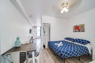 a bedroom with a bed and a table and chairs at Ocean Drive Prime Apt w/2 Queen-Beds, South Beach in Miami Beach