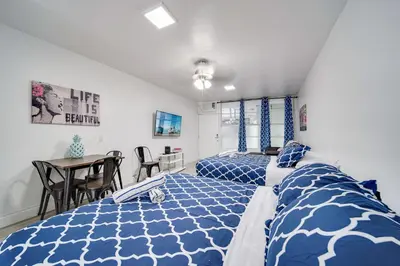 a bedroom with two beds and a table at Ocean Drive Prime Apt w/2 QueenBeds & Washer/Dryer in Miami Beach