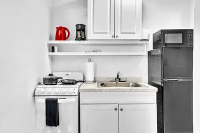 a kitchen with a sink and a stove and a refrigerator at Hollywood Beach Getaway Executive Studio Suite in Hollywood