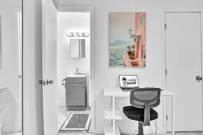 a white room with a desk and a chair at Hollywood Beach Getaway Executive Studio Suite in Hollywood