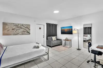 a bedroom with a bed and a chair and a desk at Hollywood Beach Getaway Executive Studio Suite in Hollywood