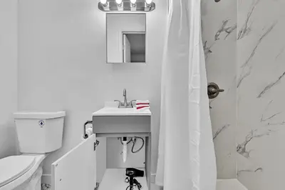 a bathroom with a toilet and a sink and a mirror at Hollywood Beach Getaway Executive Studio Suite in Hollywood