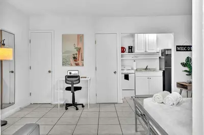 a white room with a desk and a kitchen at Hollywood Beach Getaway Executive Studio Suite in Hollywood